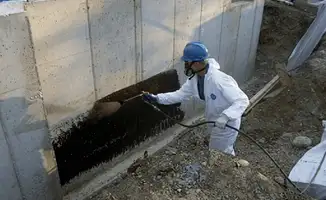 Professional waterproofing the exterior walls of the basement in Savannah, GA